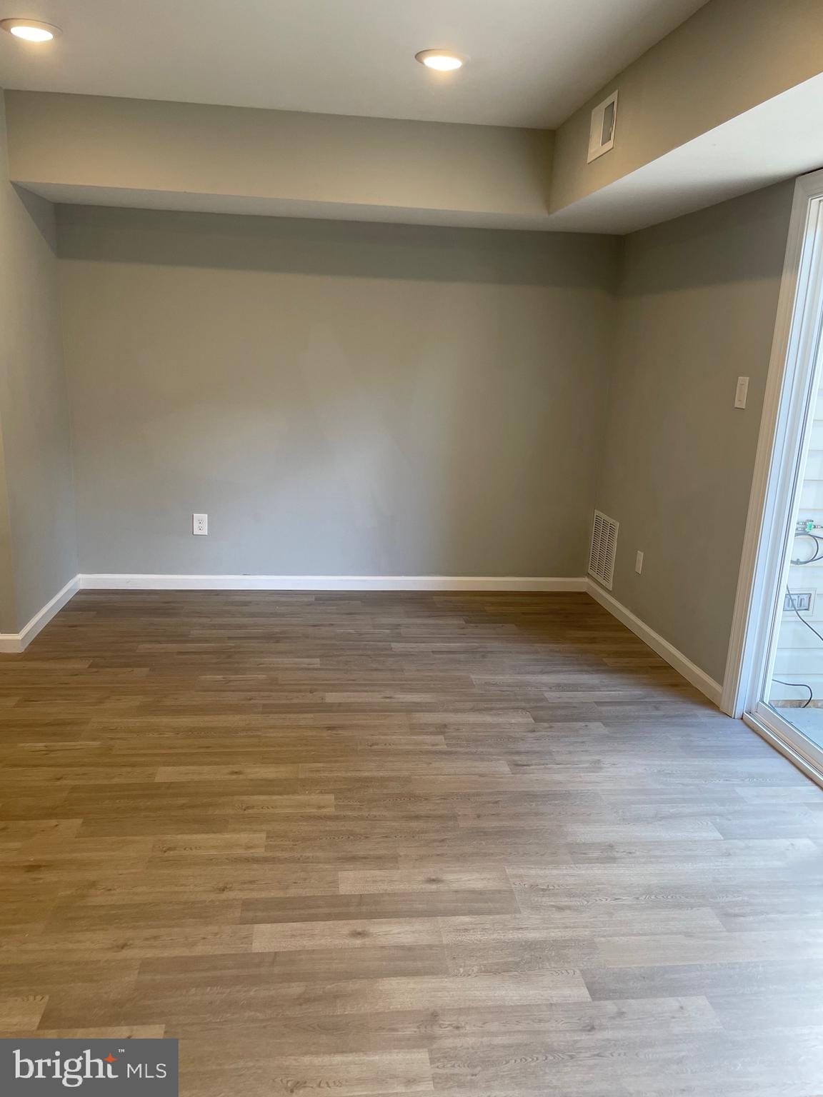 124 Andrew Place Sterling, VA 20164 - Photo 32 of 70 a view of an empty room with wooden floor