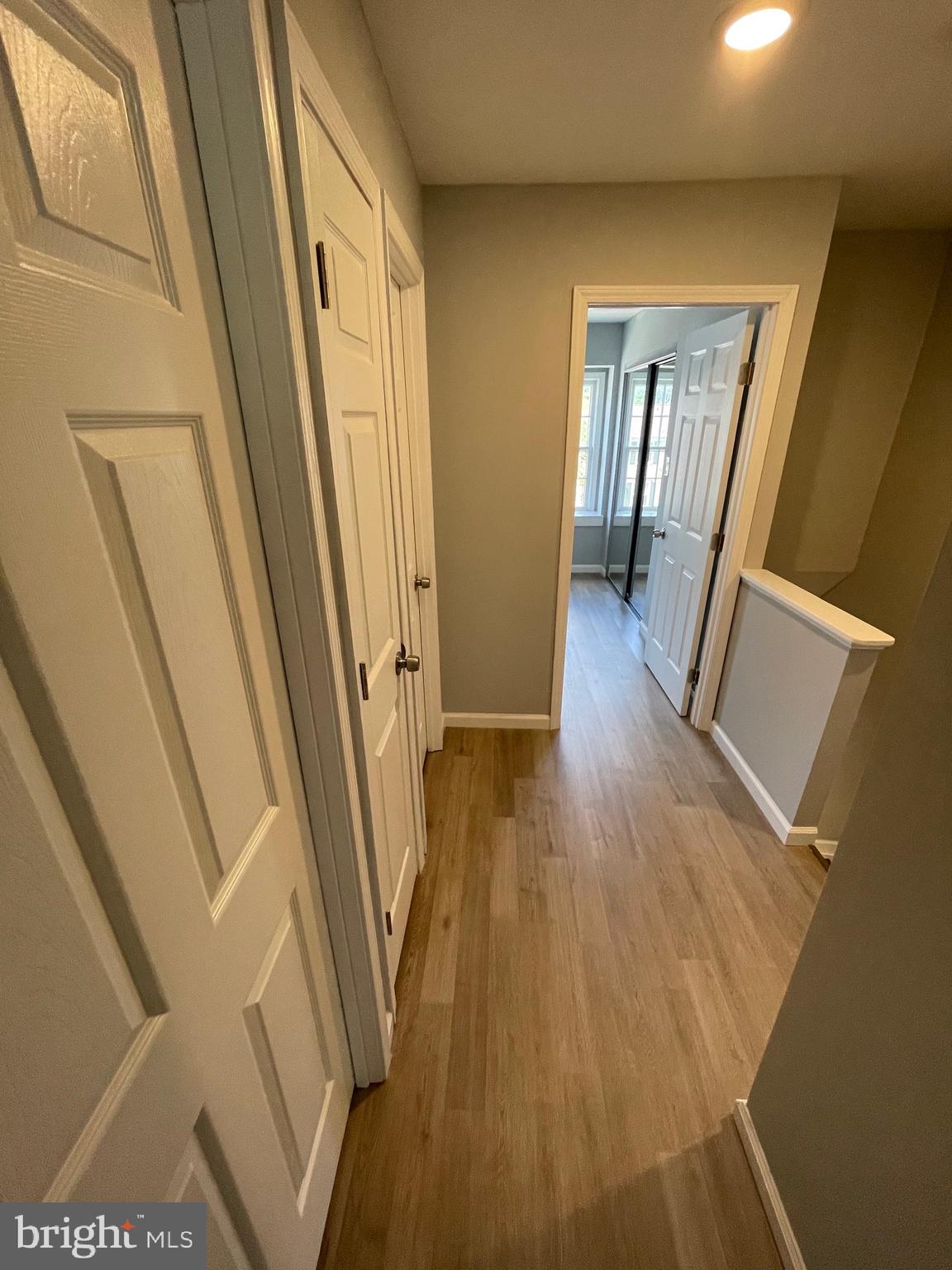 124 Andrew Place Sterling, VA 20164 - Photo 42 of 70 a view of a hallway with wooden floor and stairs