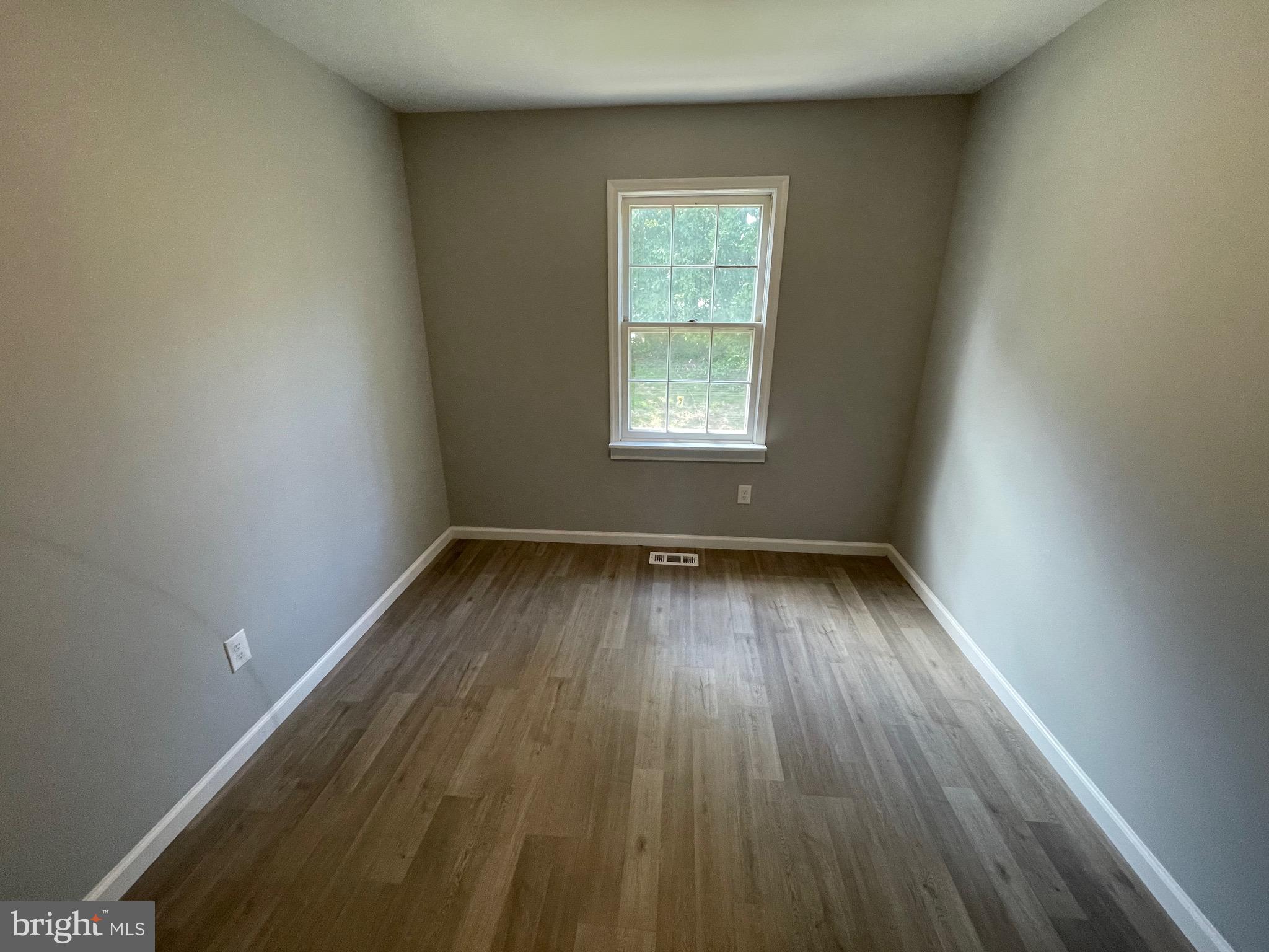 124 Andrew Place Sterling, VA 20164 - Photo 48 of 70 an empty room with wooden floor and windows