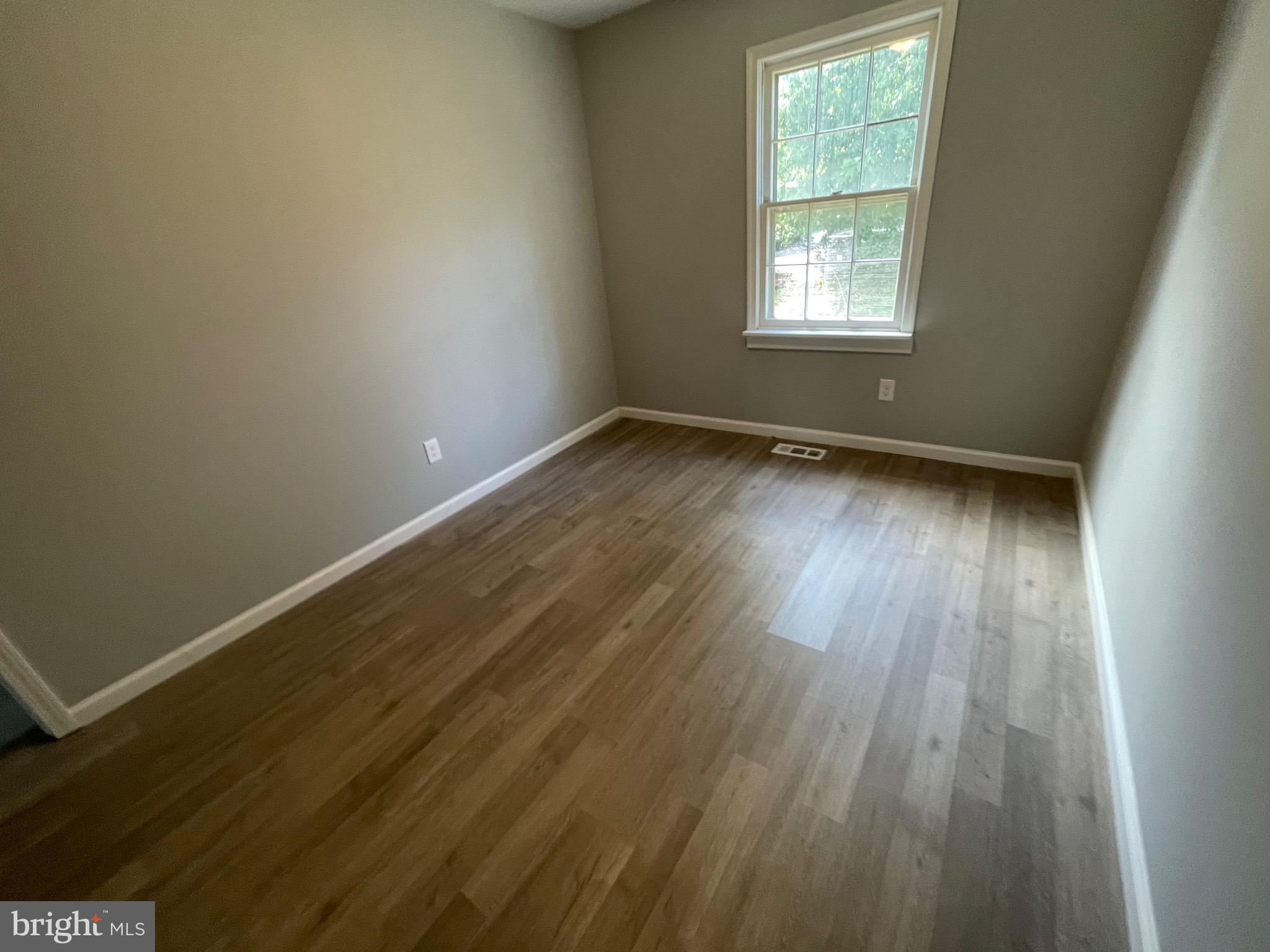 124 Andrew Place Sterling, VA 20164 - Photo 49 of 70 an empty room with wooden floor and windows