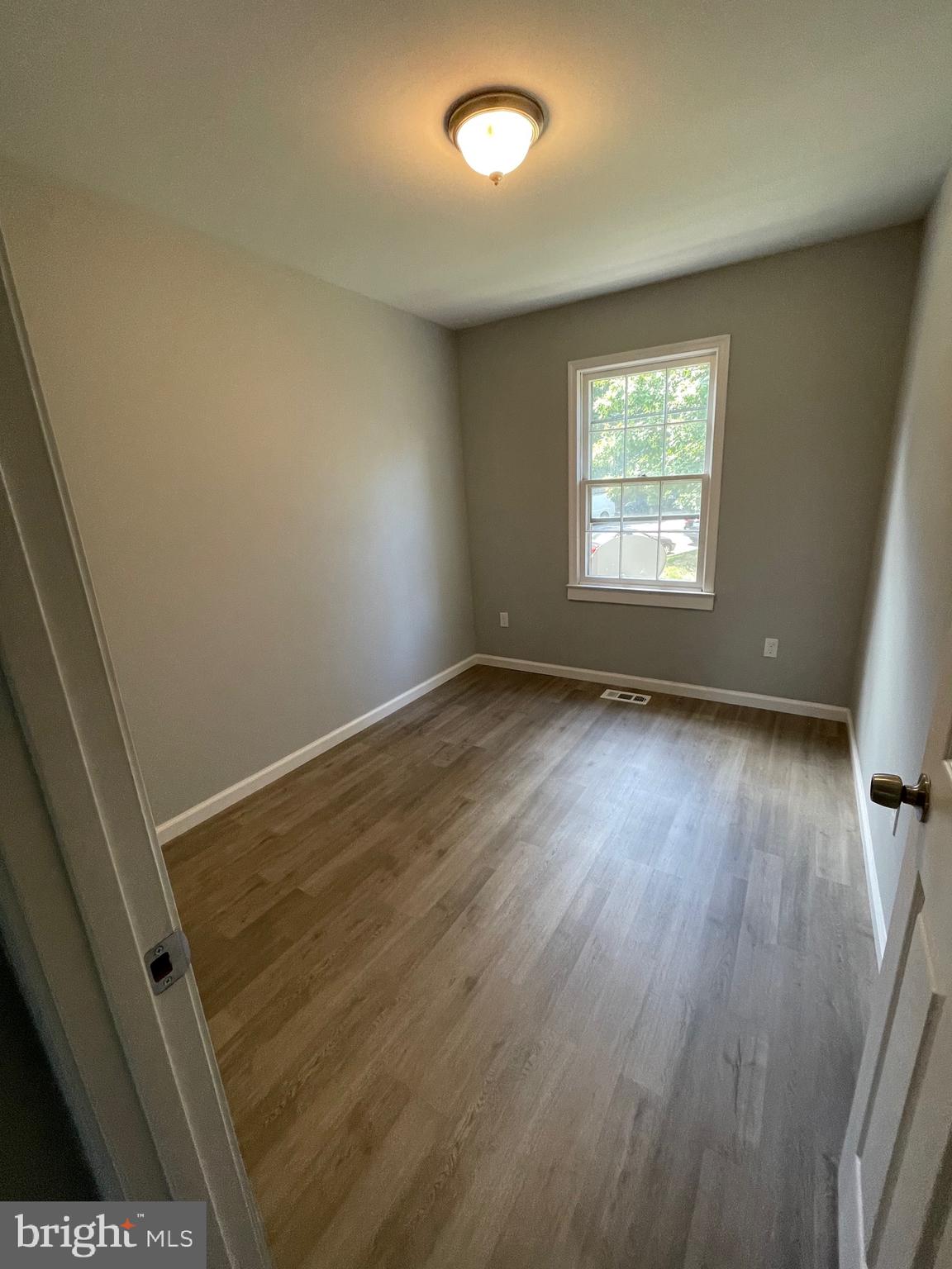 124 Andrew Place Sterling, VA 20164 - Photo 53 of 70 an empty room with wooden floor and windows