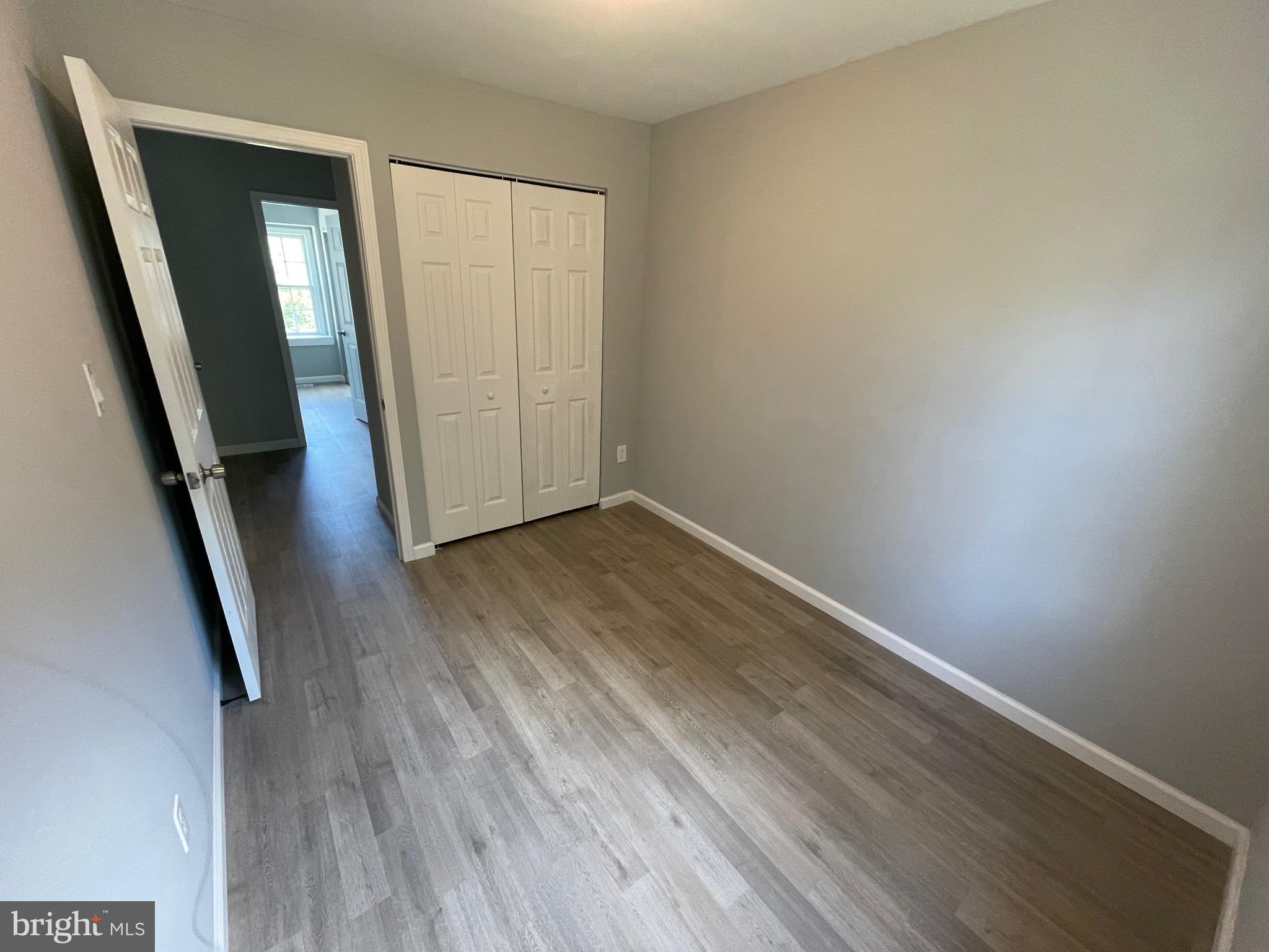 124 Andrew Place Sterling, VA 20164 - Photo 54 of 70 an empty room with wooden floor and staircase