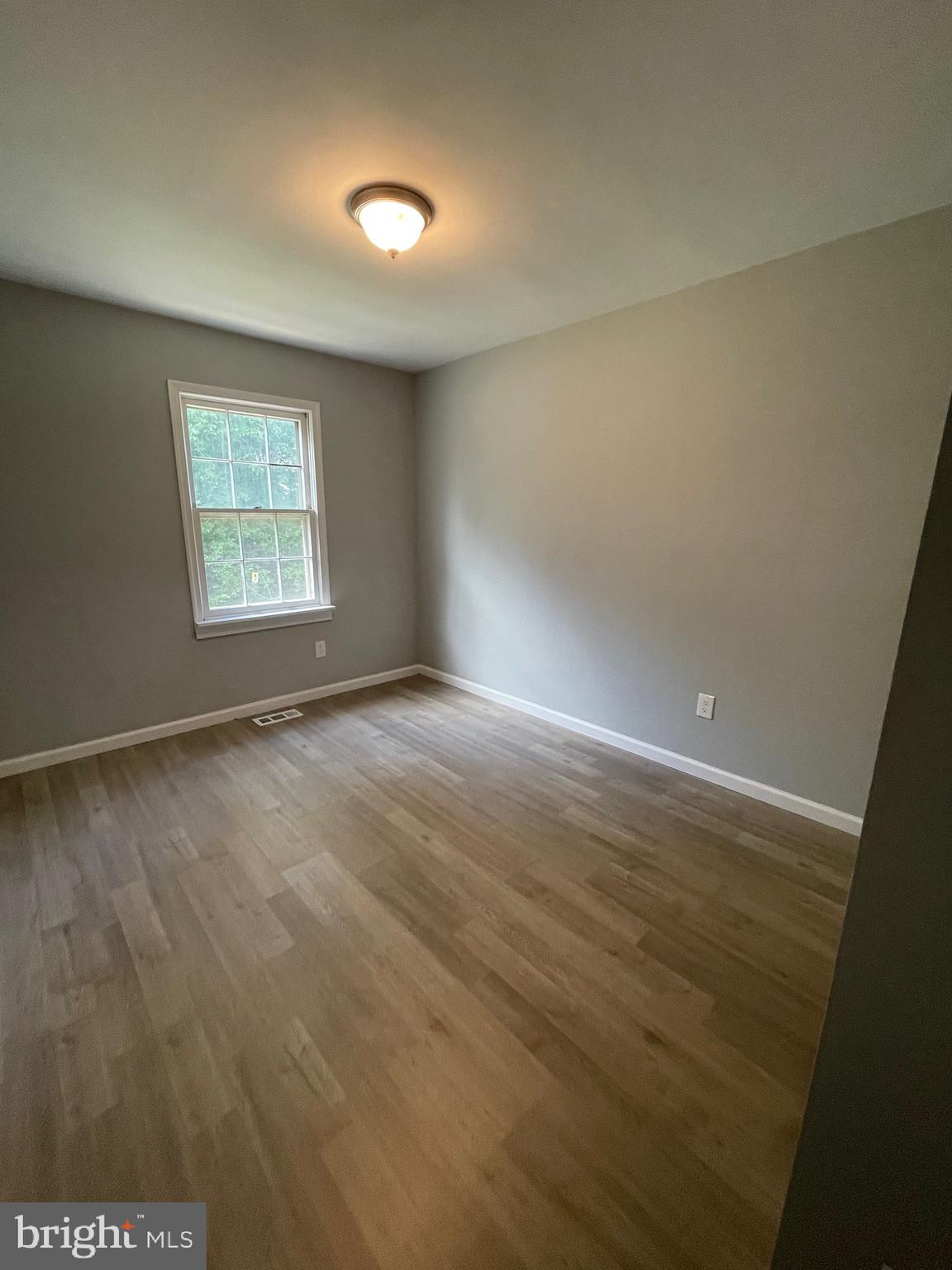 124 Andrew Place Sterling, VA 20164 - Photo 55 of 70 an empty room with wooden floor and windows
