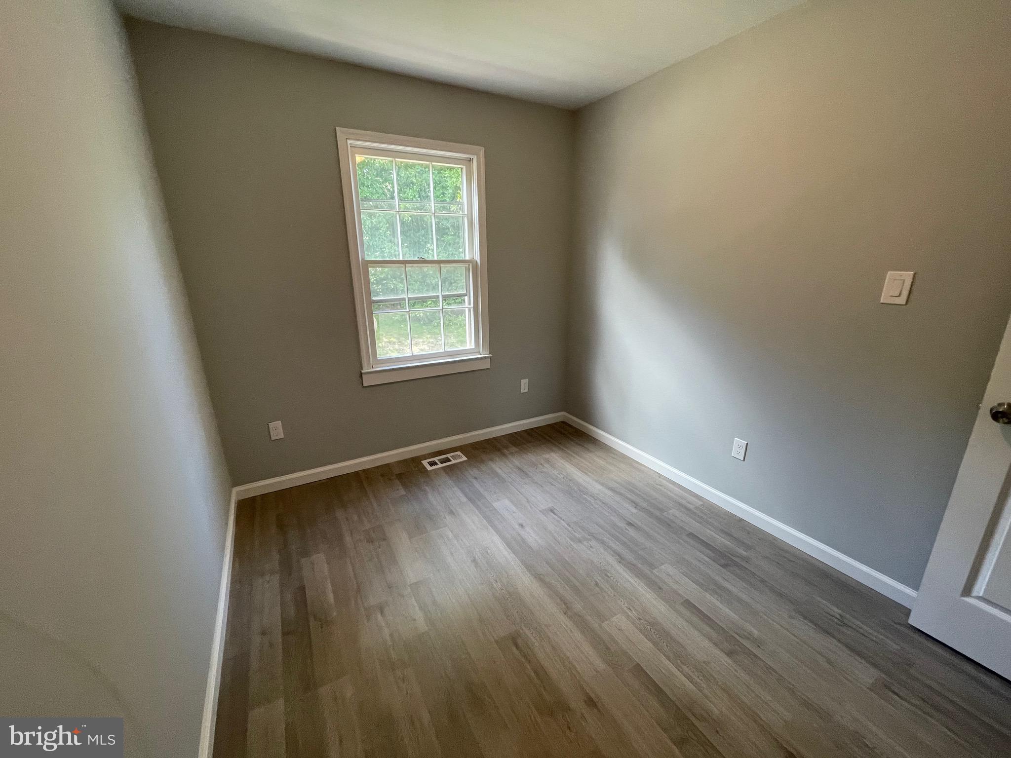 124 Andrew Place Sterling, VA 20164 - Photo 56 of 70 an empty room with wooden floor and windows