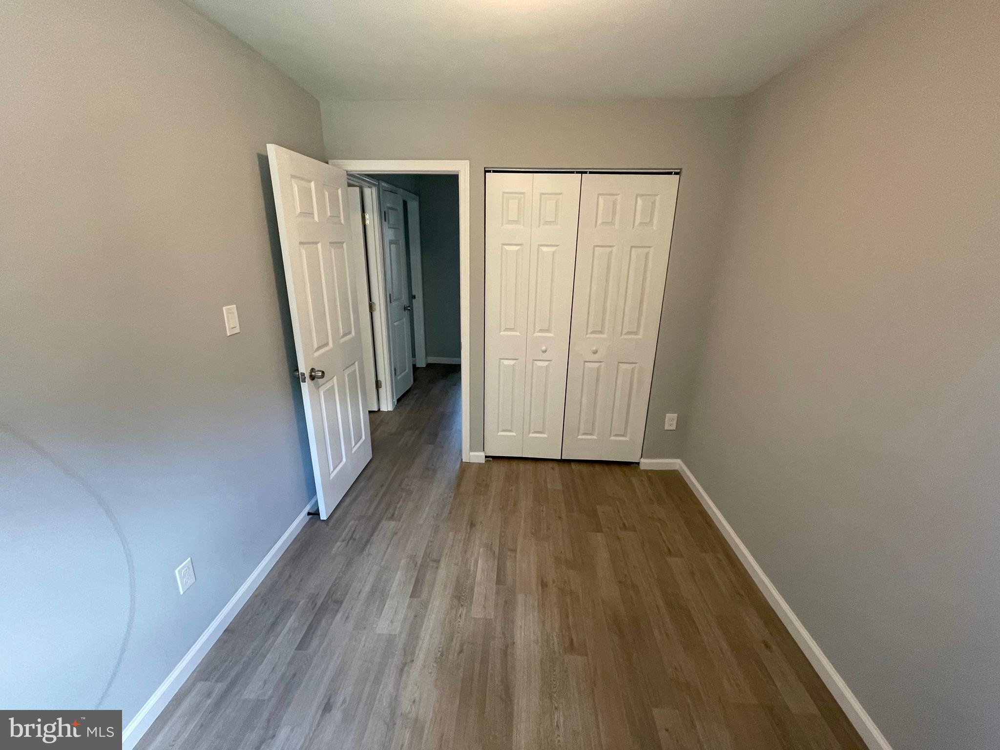 124 Andrew Place Sterling, VA 20164 - Photo 57 of 70 a view of a hallway with wooden floor and staircase