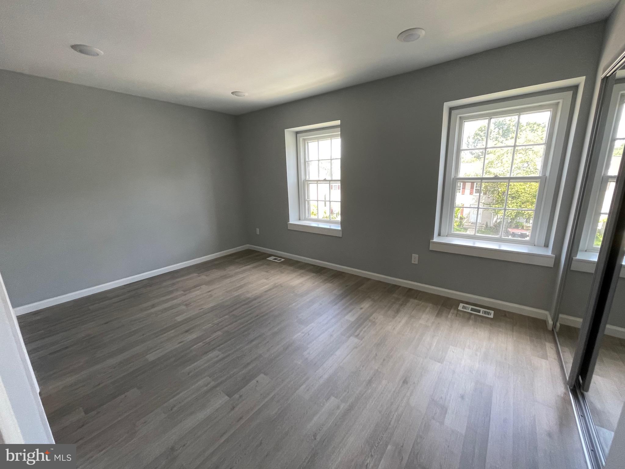 124 Andrew Place Sterling, VA 20164 - Photo 64 of 70 a view of an empty room with wooden floor and a window