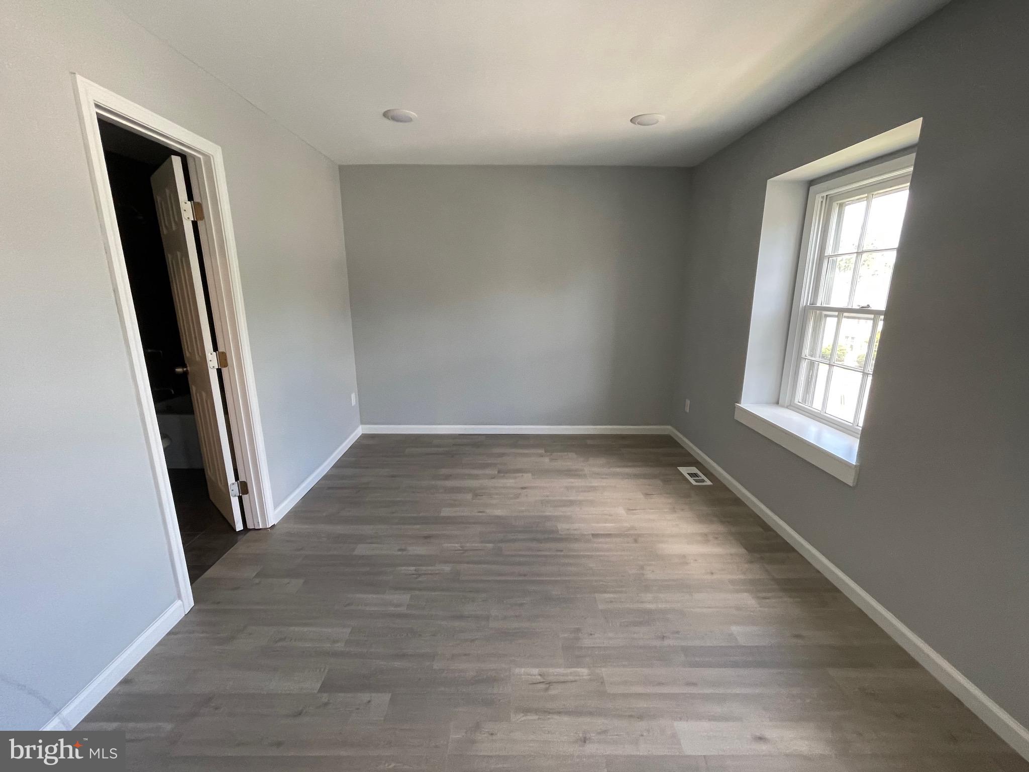 124 Andrew Place Sterling, VA 20164 - Photo 65 of 70 an empty room with wooden floor and windows