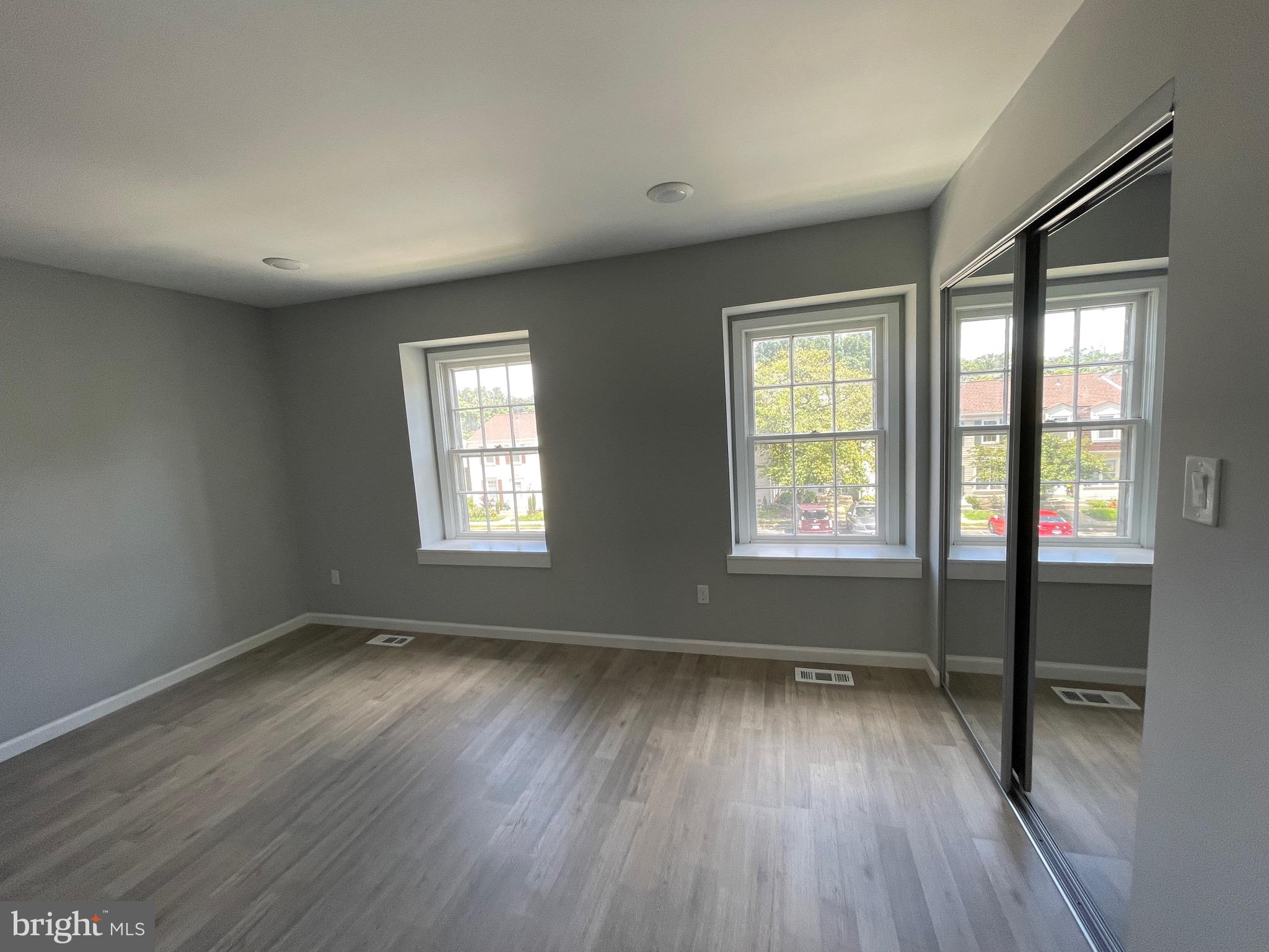 124 Andrew Place Sterling, VA 20164 - Photo 67 of 70 an empty room with wooden floor and windows