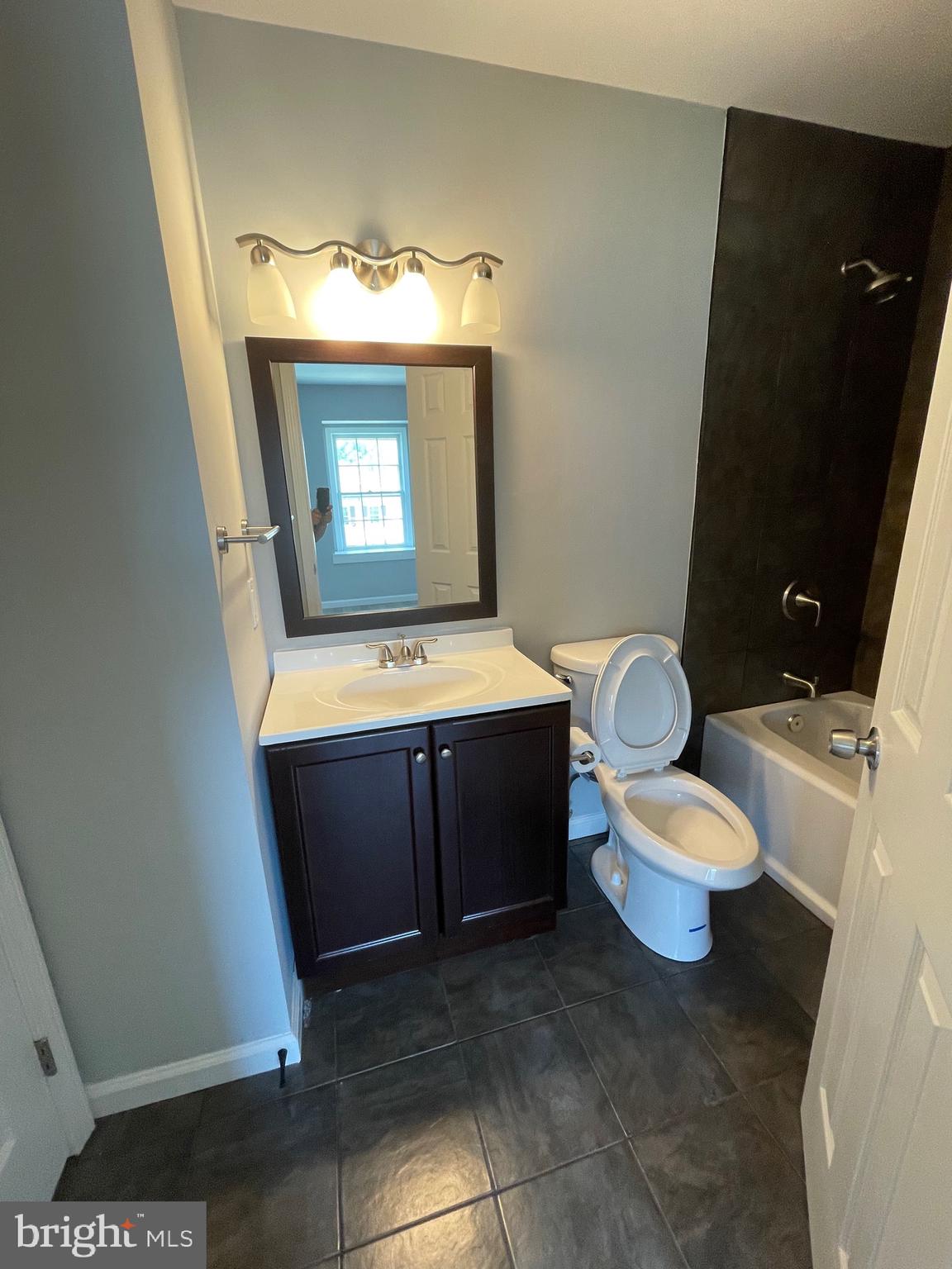 124 Andrew Place Sterling, VA 20164 - Photo 69 of 70 a bathroom with a toilet a sink and mirror
