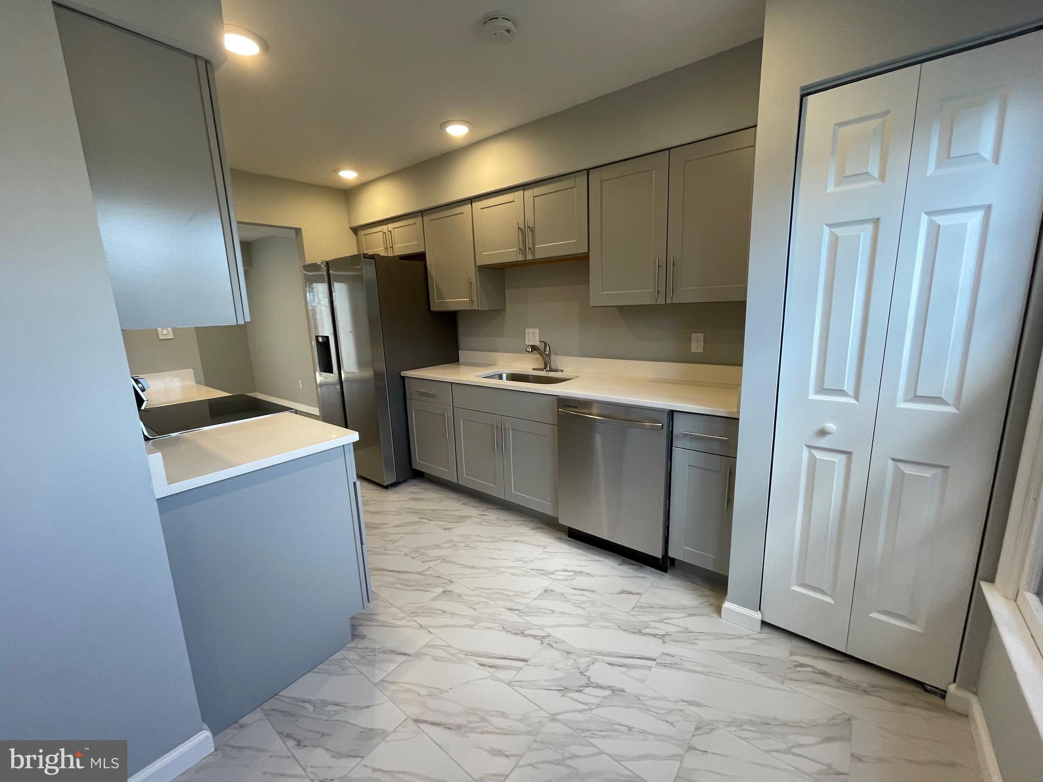 124 Andrew Place Sterling, VA 20164 - Photo 7 of 70 a kitchen with stainless steel appliances a refrigerator and a sink