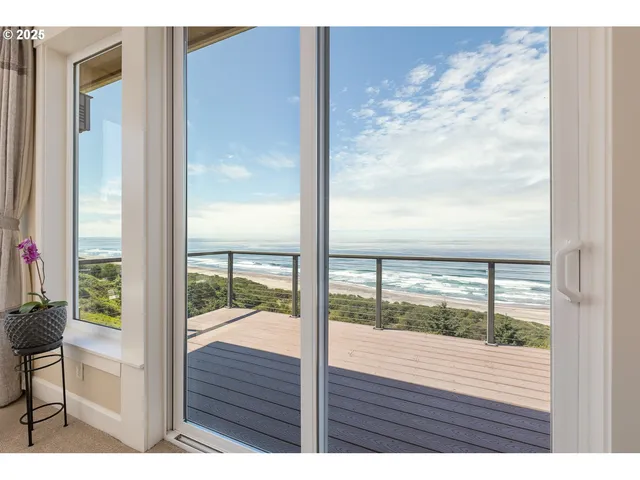 a living room with furniture and large windows