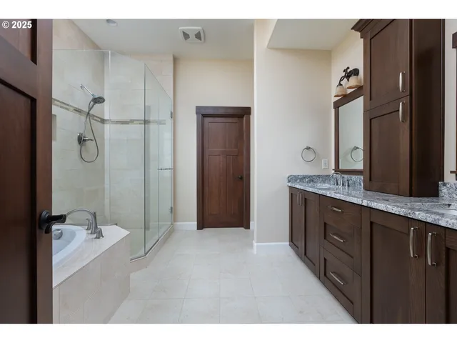a bathroom with a shower sink and mirror