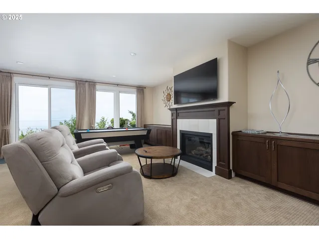 a room with pool table and windows