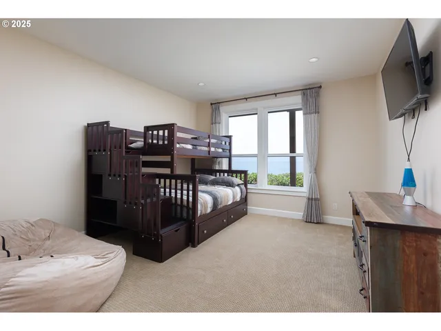 a bedroom with a large bed and a large window