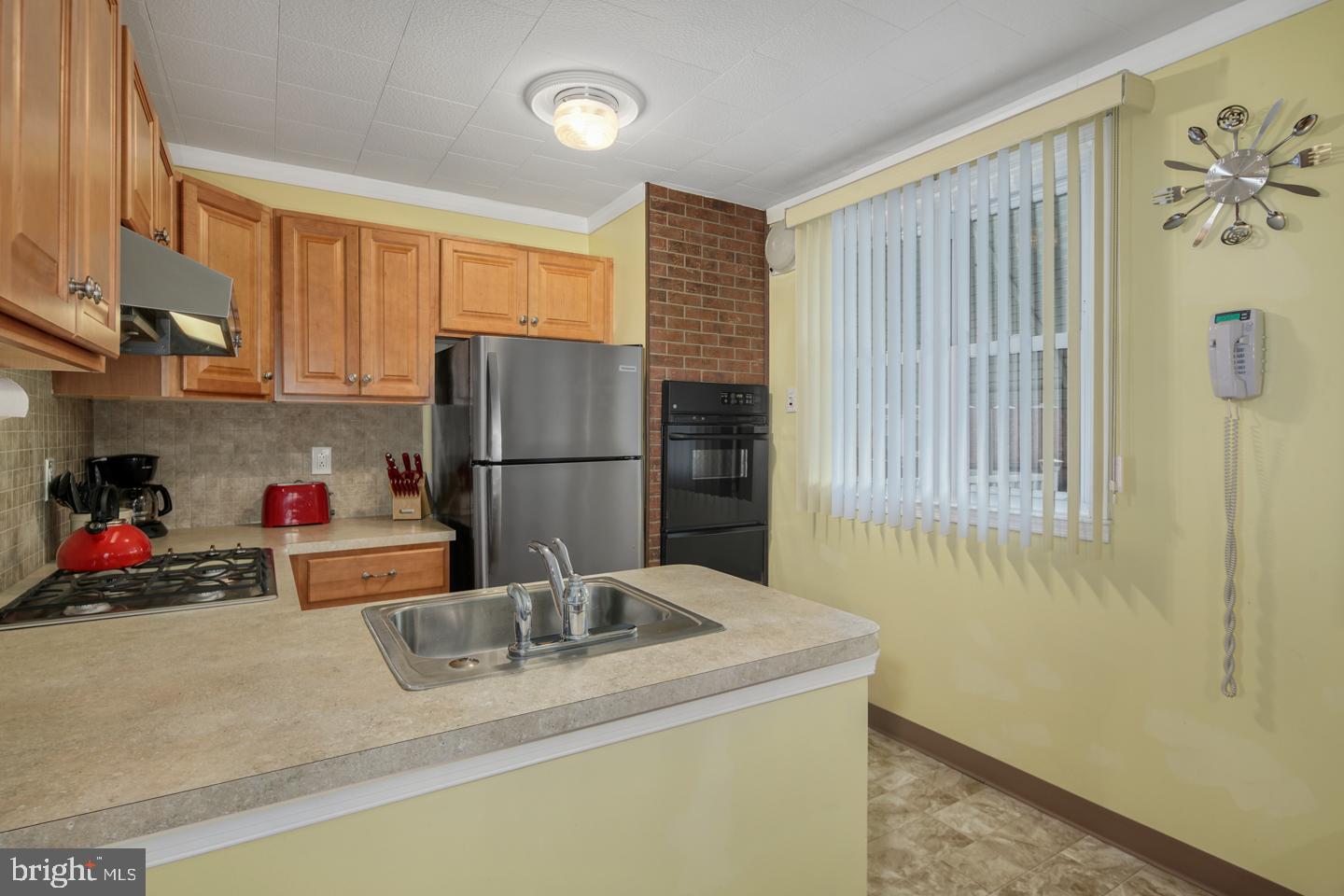 10803 Pedrick Road Philadelphia, PA 19154 - Photo 11 of 25 a kitchen with a refrigerator and a sink