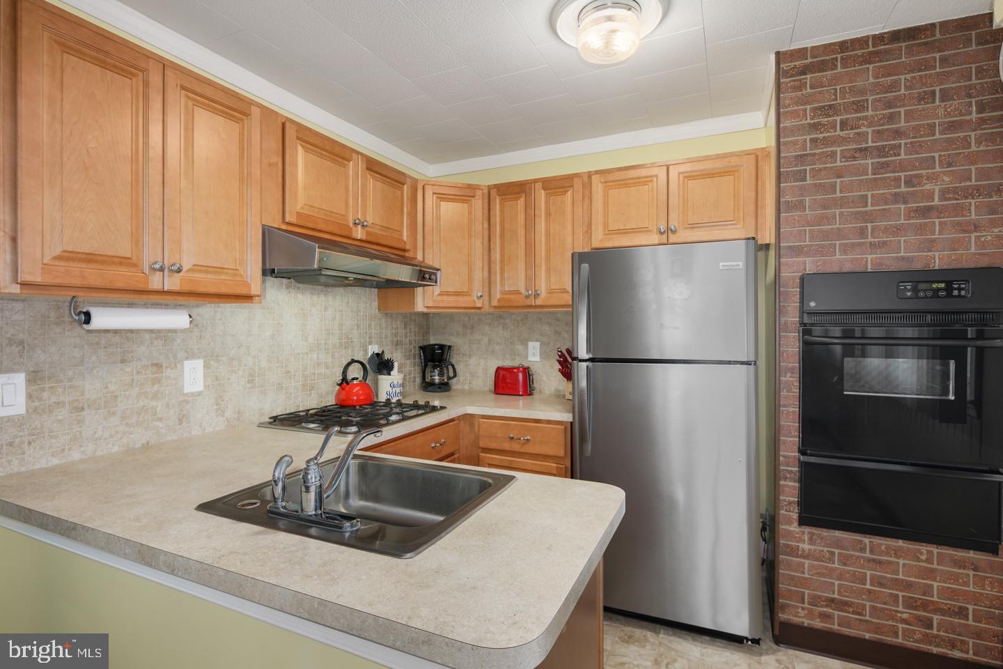 10803 Pedrick Road Philadelphia, PA 19154 - Photo 13 of 25 a kitchen with refrigerator and cabinets