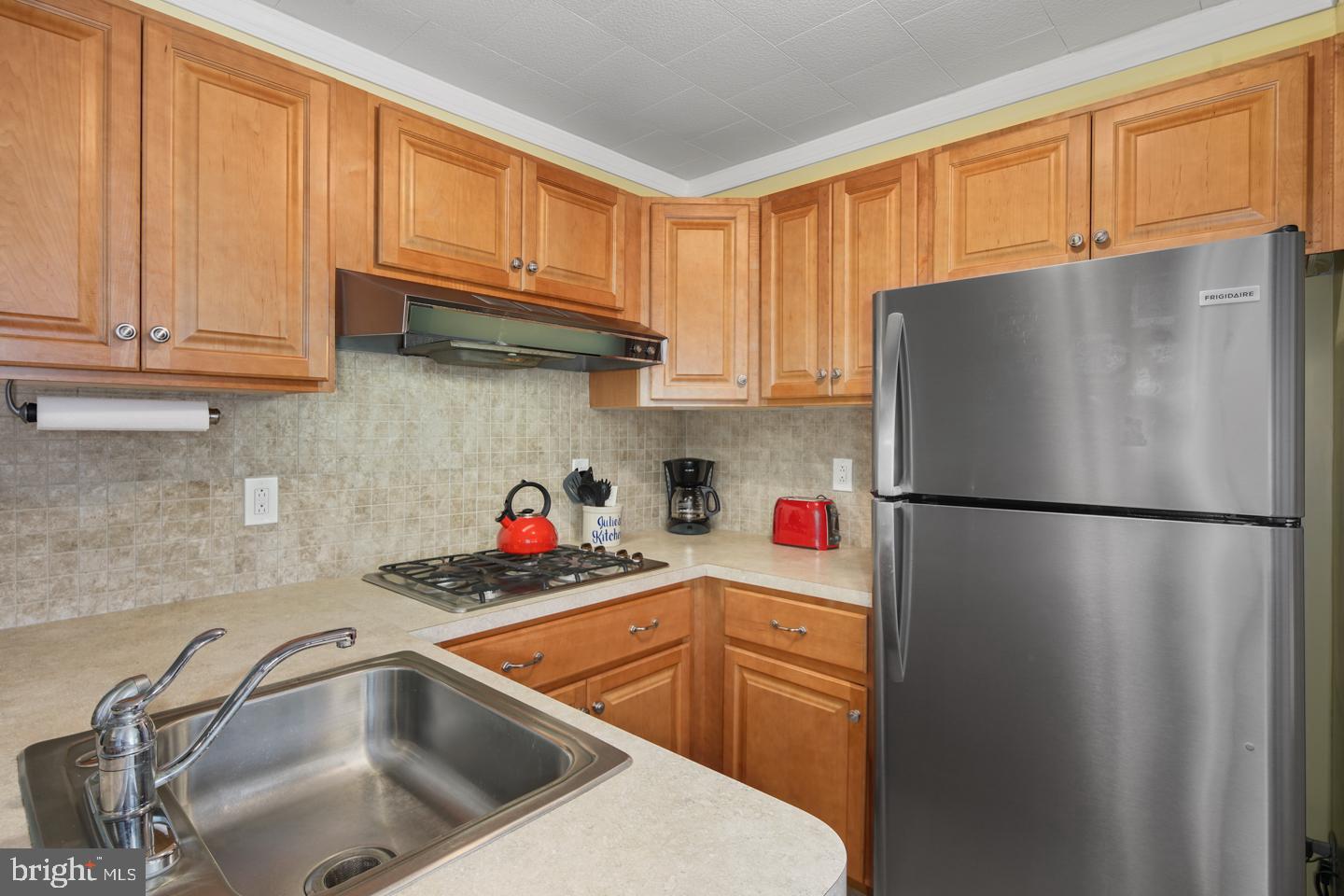 10803 Pedrick Road Philadelphia, PA 19154 - Photo 14 of 25 a kitchen with stainless steel appliances a refrigerator sink and cabinets