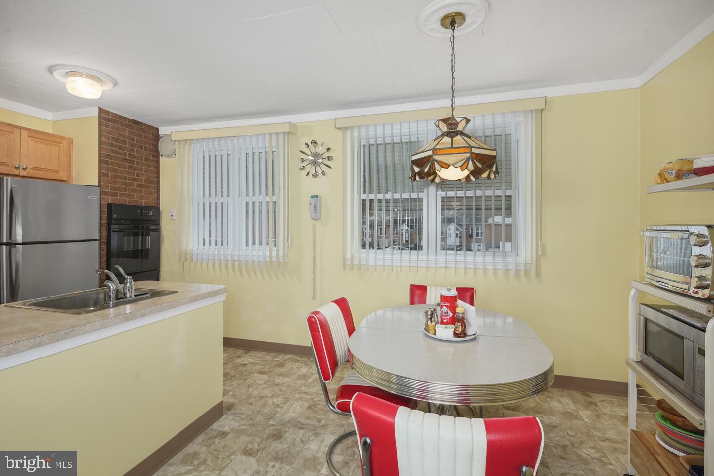 10803 Pedrick Road Philadelphia, PA 19154 - Photo 10 of 25 a dining room with furniture a chandelier and window