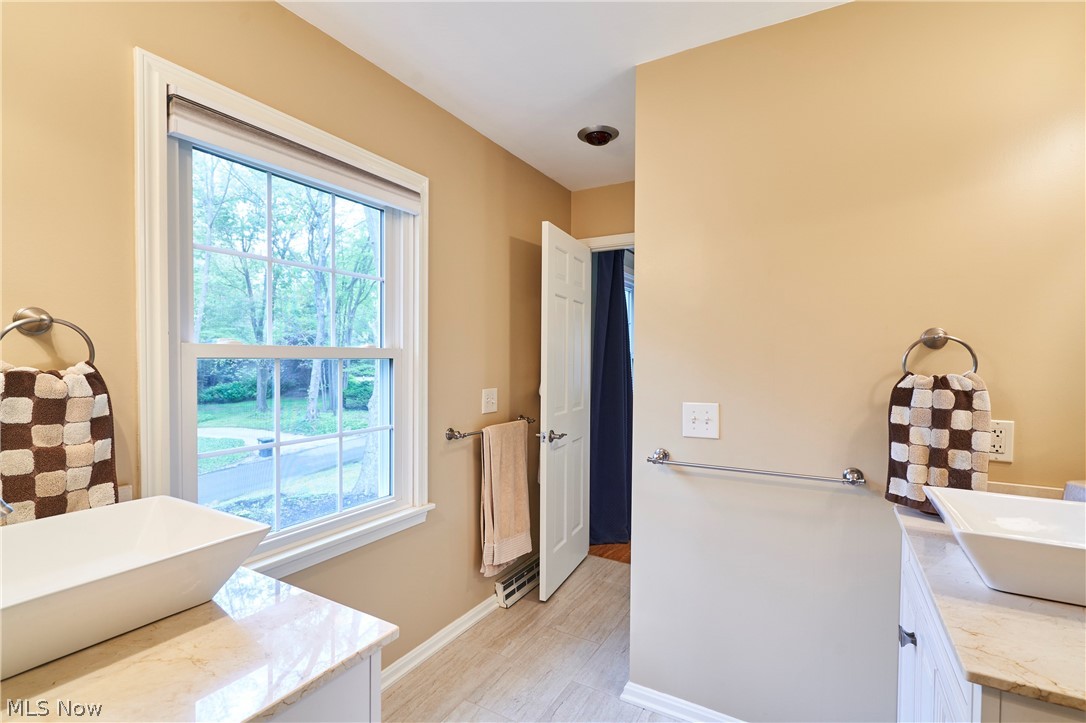 475 Somerset Road Akron, OH 44313 - Photo 13 of 30 Jack n Jill bathroom has been tastefully remodeled with 2 vanities, tile floor and tile shower.