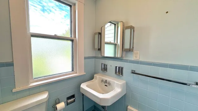 a bathroom with a sink a window and a mirror