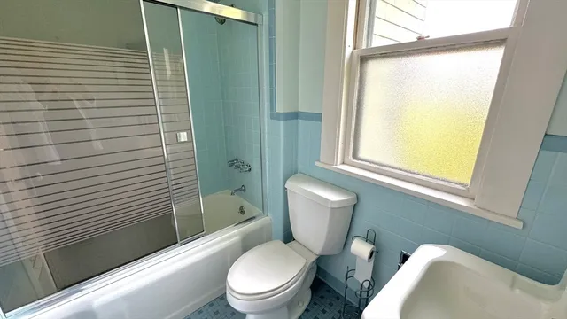 a white toilet sitting next to a bathroom sink