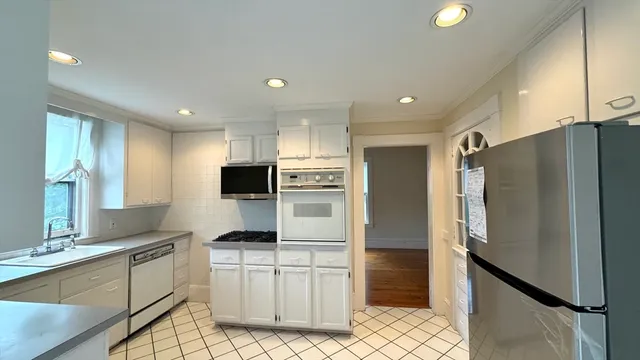 a kitchen with a refrigerator and a sink