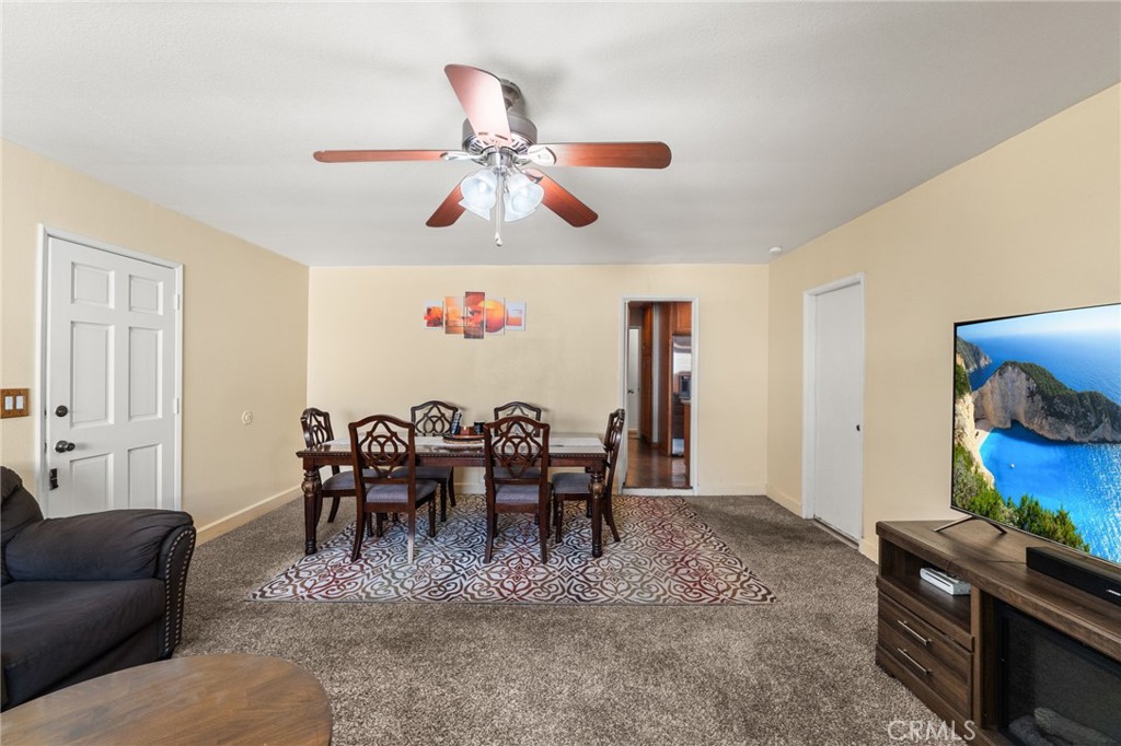 7221 Ramona Avenue Rancho Cucamonga, CA 91701 - Photo 12 of 30 a view of a dining room with furniture and a chandelier fan
