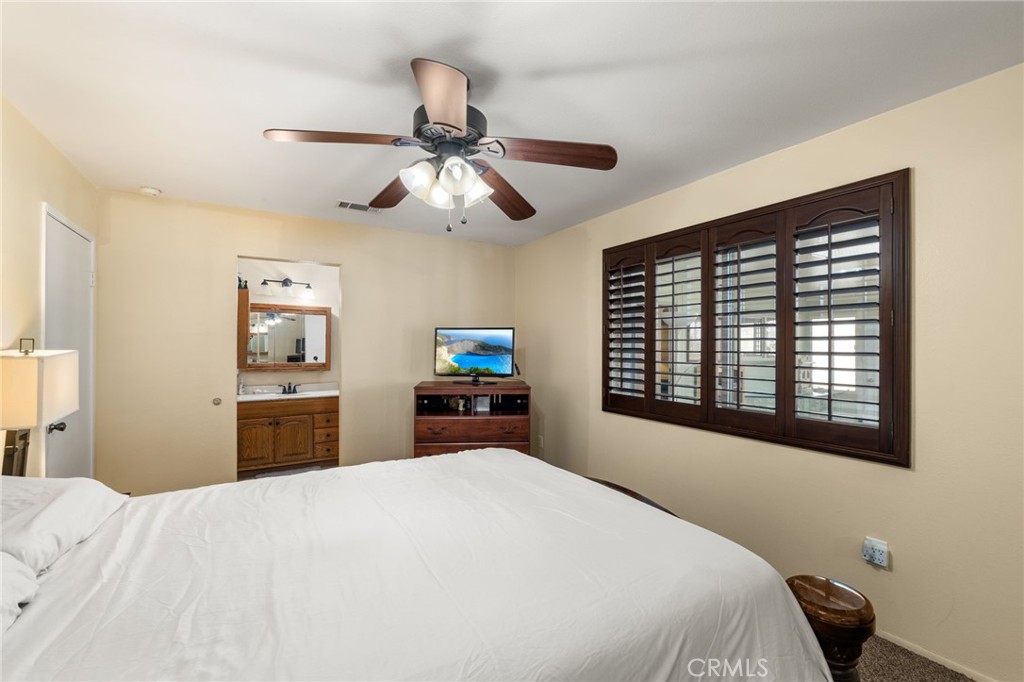 7221 Ramona Avenue Rancho Cucamonga, CA 91701 - Photo 14 of 30 a bedroom with a bed dresser and a large window