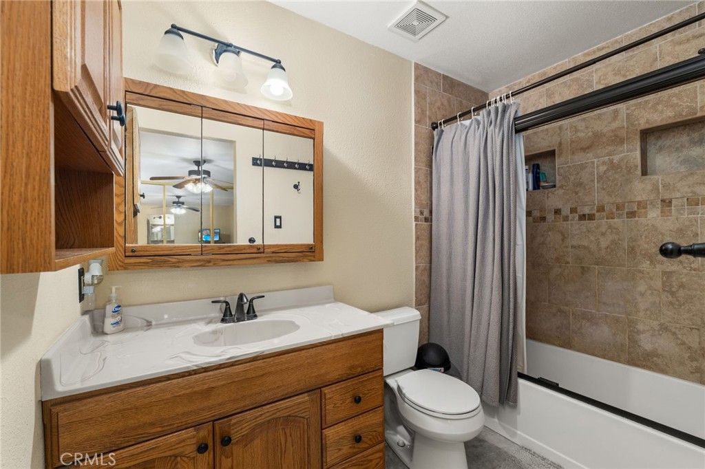 7221 Ramona Avenue Rancho Cucamonga, CA 91701 - Photo 15 of 30 a bathroom with a granite countertop sink toilet and shower