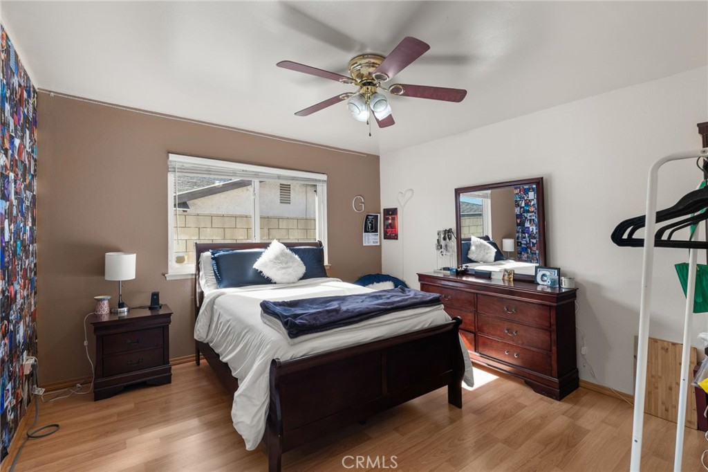 7221 Ramona Avenue Rancho Cucamonga, CA 91701 - Photo 16 of 30 a bedroom with a bed and wooden floor