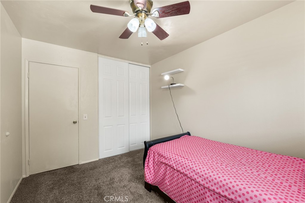7221 Ramona Avenue Rancho Cucamonga, CA 91701 - Photo 20 of 30 a bedroom with a bed and a chandelier fan