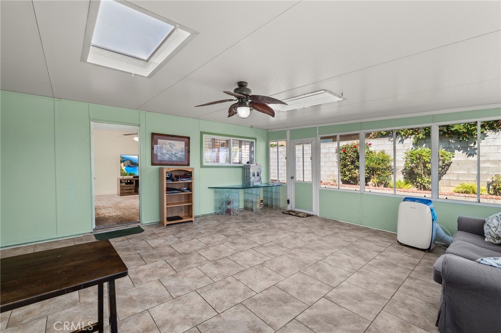 7221 Ramona Avenue Rancho Cucamonga, CA 91701 - Photo 22 of 30 a living room with furniture a window and a flat screen tv