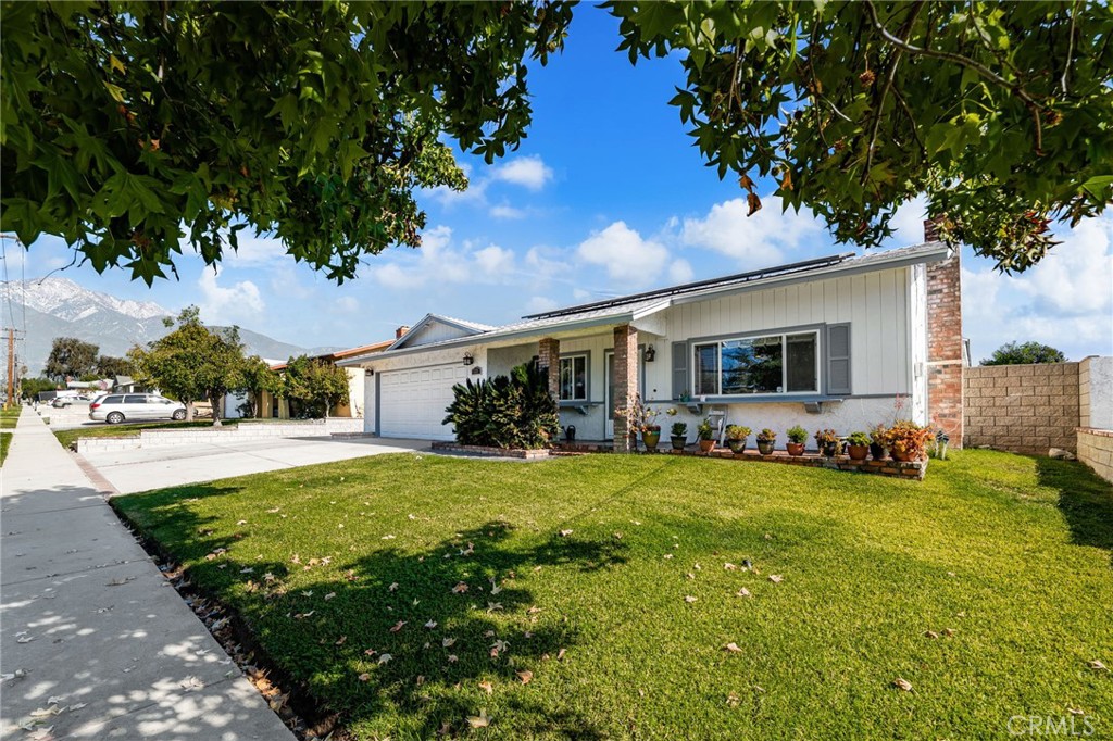 7221 Ramona Avenue Rancho Cucamonga, CA 91701 - Photo 3 of 30 a view of a house with a yard