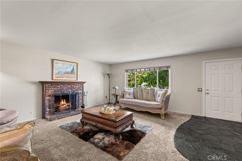 7221 Ramona Avenue Rancho Cucamonga, CA 91701 - Photo 4 of 30 a living room with furniture and a fireplace