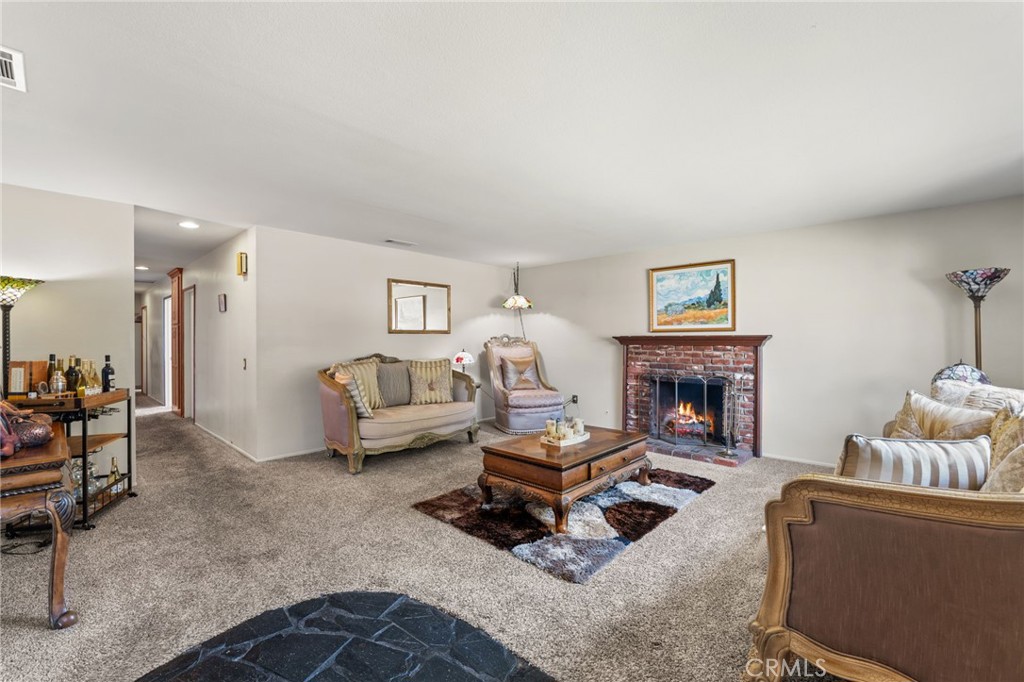 7221 Ramona Avenue Rancho Cucamonga, CA 91701 - Photo 6 of 30 a living room with furniture and a fireplace