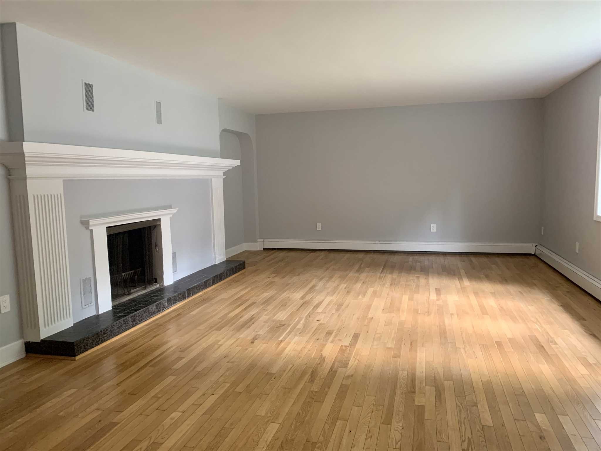 5 Alexander Road East Fishkill, NY 12533 - Photo 2 of 33 a view of empty room with wooden floor and fireplace