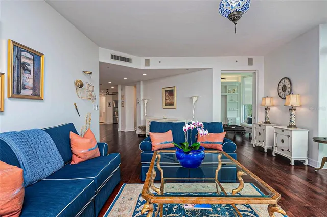 a living room with furniture and a book shelf