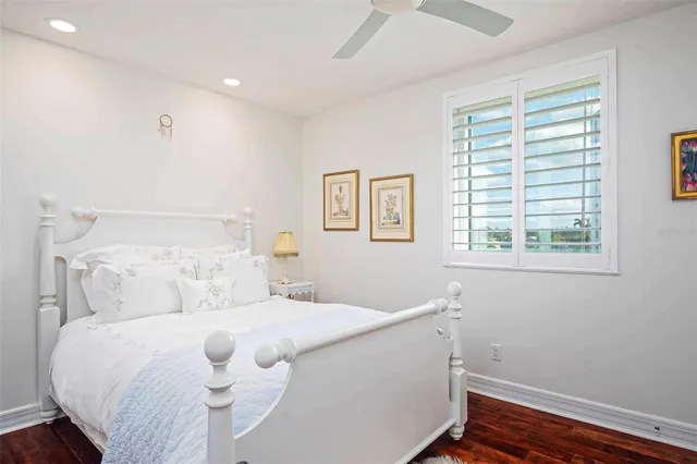 a bathroom with a granite countertop sink mirror vanity and toilet