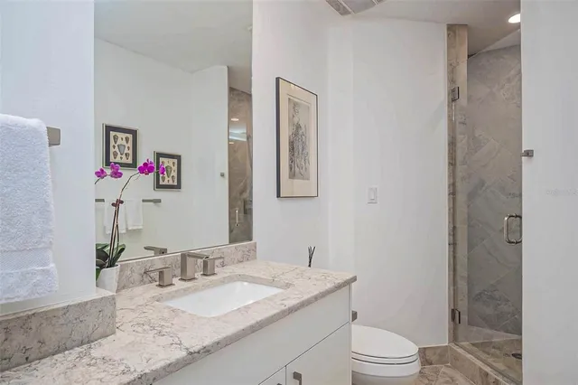 a balcony with furniture and a potted plant