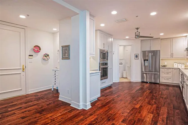 a kitchen with granite countertop white cabinets and sink