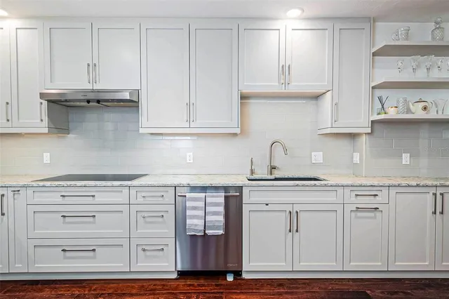 a kitchen with stainless steel appliances granite countertop a stove and a microwave