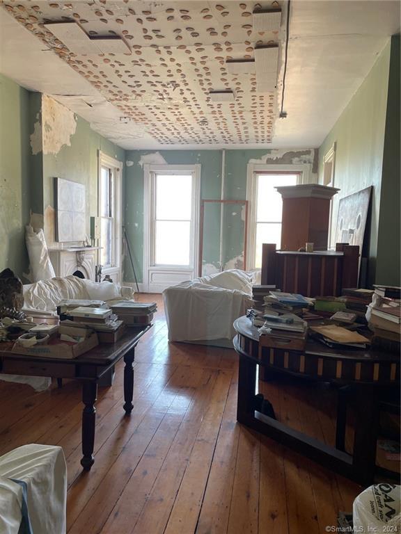 a open kitchen with stainless steel appliances granite countertop a stove and a wooden floors