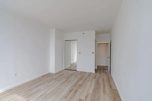 a view of a room with wooden floor