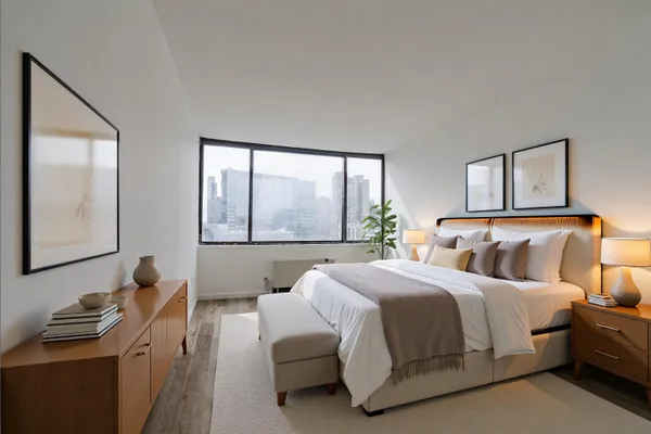 a bedroom with a bed and wooden floor