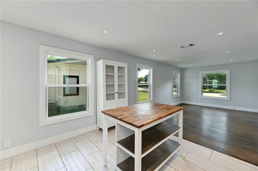 8318 Burrell Drive Austin, TX 78757 - Photo 11 of 27 an open kitchen with white cabinets and wooden floor