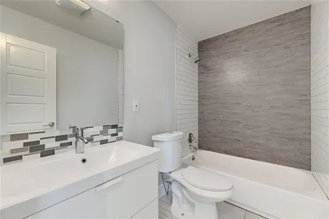 a bathroom with a sink a toilet and a bathtub