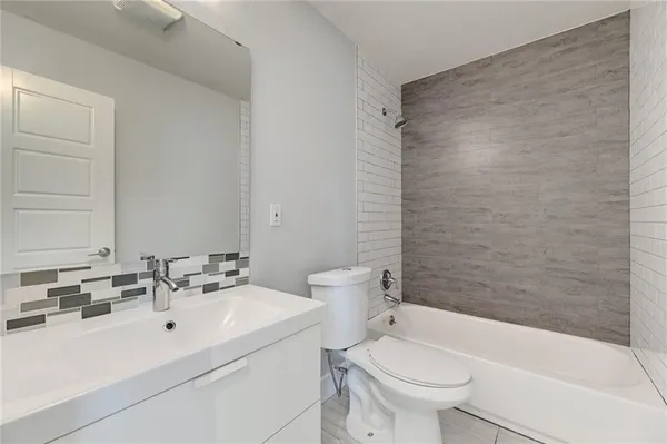 a bathroom with a sink a toilet and a bathtub