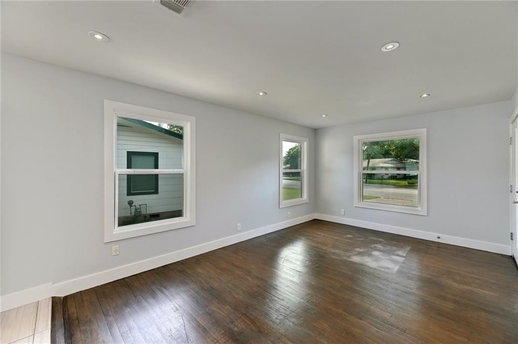 8318 Burrell Drive Austin, TX 78757 - Photo 4 of 27 an empty room with wooden floor and windows