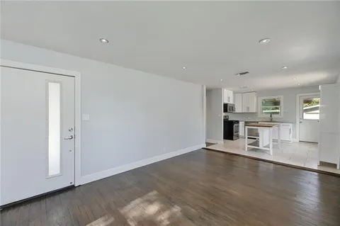 a view of kitchen with stove and cabinets