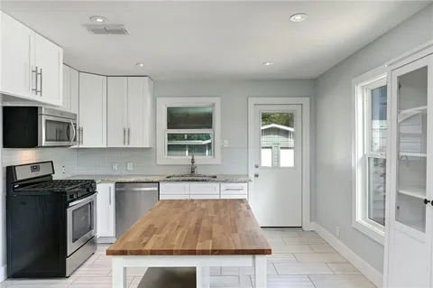 a kitchen with a sink cabinets and window